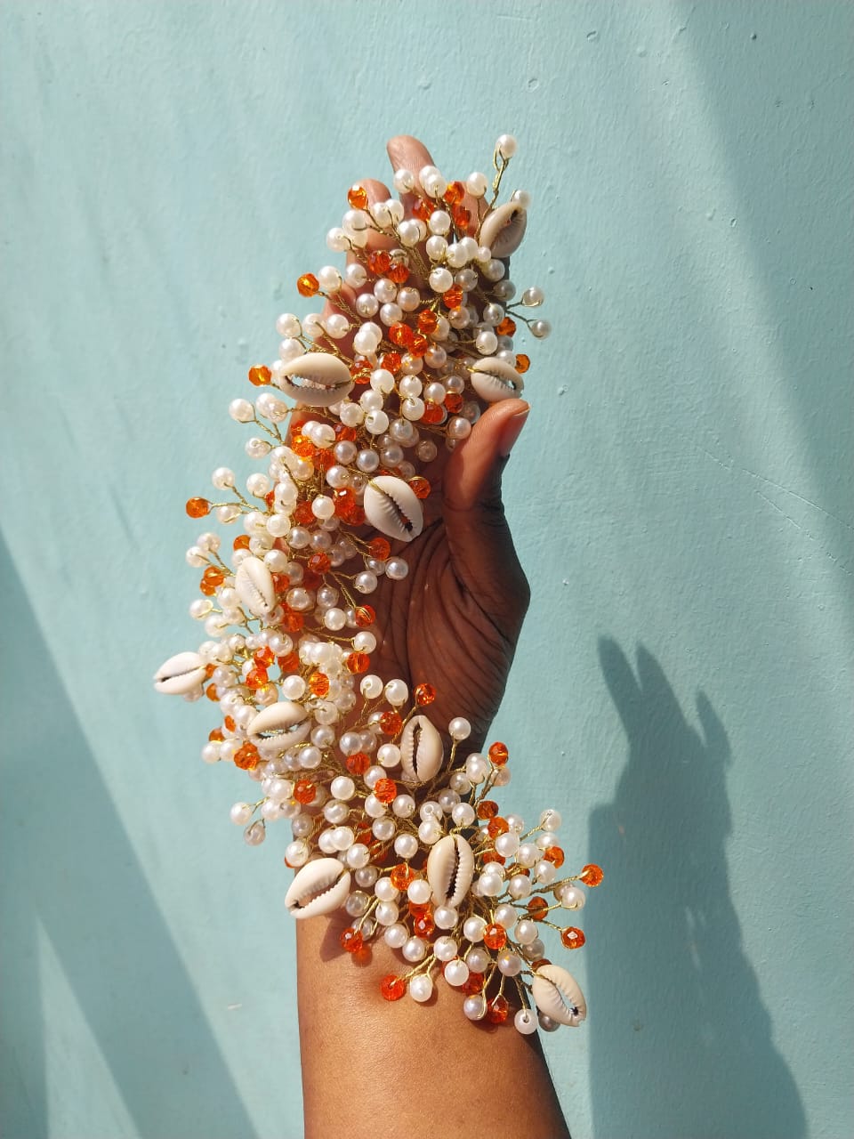 Detailed orange and white with cowrie shells