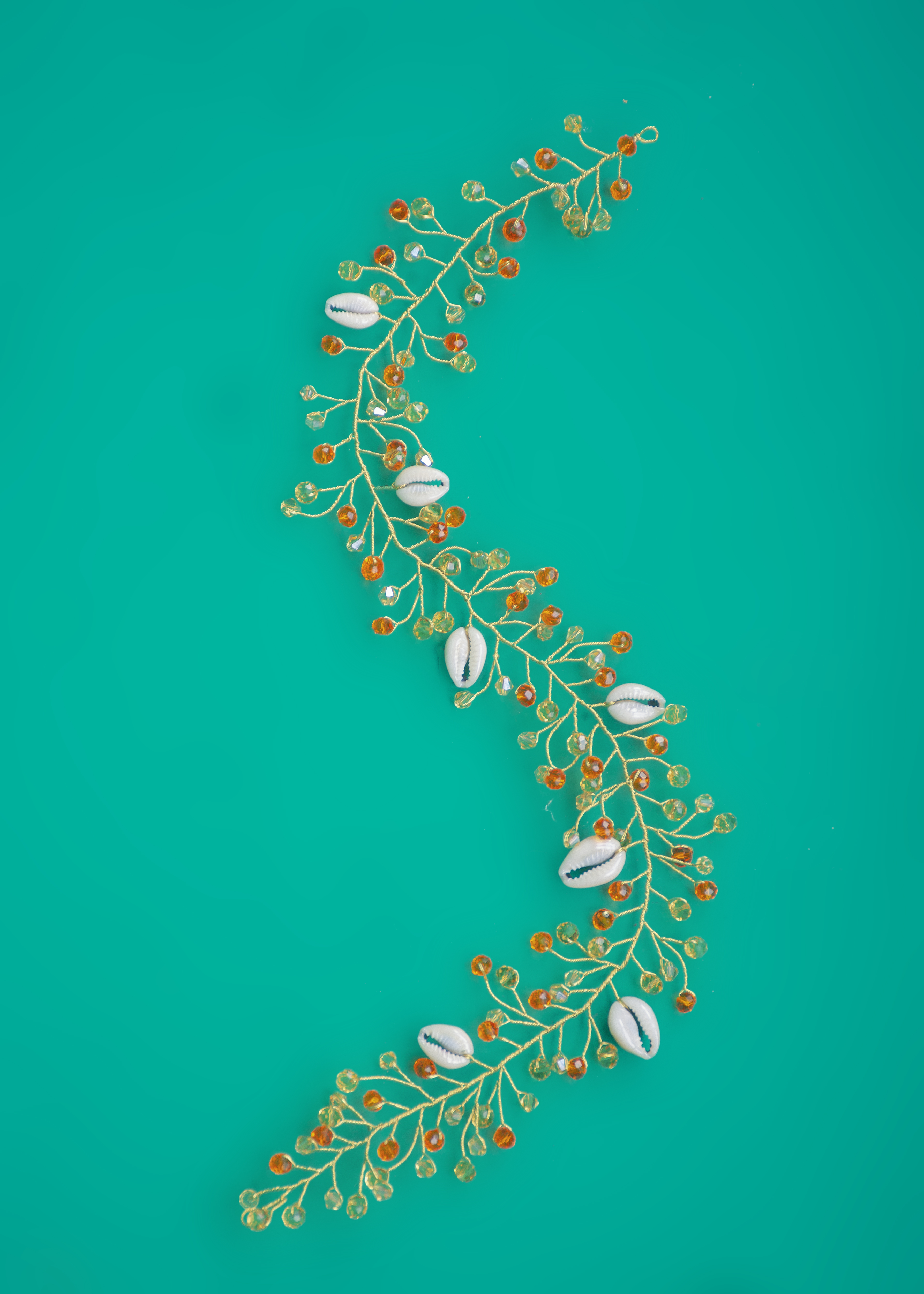 Orange, gold, and cowrie shells hairvine